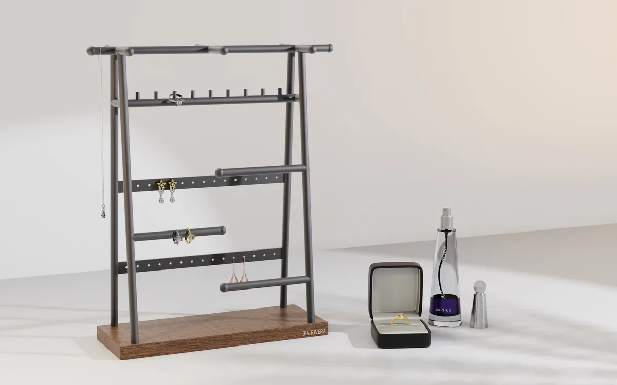A-frame ladder-style matte black steel Gia Rivera jewellery stand on a walnut base, hung with a necklace, earrings and rings.
